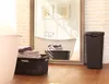 A bathroom scene with laundry baskets and towels, reflected in a large mirror. Podgląd zdjęcia produktu