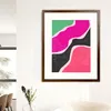 A framed abstract art print hanging on a white wall above a sofa and a vase with flowers. Anteprima dell’immagine prodotto