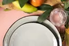A table setting with plates, fruit, and a glass of water. Náhled obrázku produktu