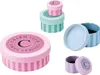 A collection of small, decorative round boxes with striped patterns and branding. Anteprima dell’immagine prodotto