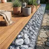 Grau-weiß gemaserte Kieselsteine in einer Gabionenbank neben einer Holzterrasse Produktbild-Vorschau