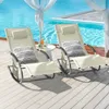 Two beige rocking lounge chairs are set up on a wooden deck next to a swimming pool, with sheer white curtains in the background. Náhľad obrázku produktu