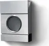 A modern, brushed metal mailbox mounted on a white wall, casting a shadow. Produktbild-Vorschau