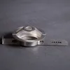 A silver metal cookie press attachment is shown on a dark gray surface. Produktbild-Vorschau