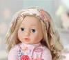 Close-up of a Baby Annabell doll with blonde hair and blue eyes, wearing a pink outfit. Produktbild-Vorschau