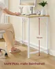 A person is sitting at a desk, working on a computer. The desk has a monitor, keyboard, mouse, and a small alarm clock on it. A vase with a plant is also on the desk. The desk has a white metal frame and a wood-effect top. A measurement of 71.5 cm is indic Produktbild-Vorschau