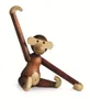 A wooden monkey toy sitting on a white background. Náhled obrázku produktu