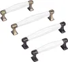 A group of cabinet handles with white ceramic inserts and metal bases. Produktbild-Vorschau