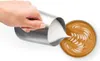 A hand is pouring milk into a cup of coffee, creating latte art. Produktbild-Vorschau