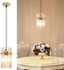 A split image showing a pendant light fixture on the left and a dining table setting with a floral arrangement on the right. Anteprima dell’immagine prodotto