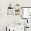 A white bathroom cabinet mounted on a white tiled wall, with various bathroom accessories on and around it. Náhled obrázku produktu