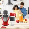 A man and woman are in a kitchen, smiling and interacting while a blender and a glass of juice are on a wooden counter. Produktbild-Vorschau