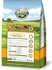 A bag of dog food with a scenic background of fields and a house. Produktbild-Vorschau