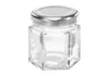 A small, hexagonal glass jar with a silver lid, isolated on a white background. Voir les images du produit