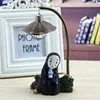 A decorative lamp ornament of a character from Japanese animation, placed in front of a white photo frame. Produktbild-Vorschau