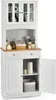 A white freestanding kitchen storage cabinet with a wooden top and glass doors on the upper section. Podgląd zdjęcia produktu