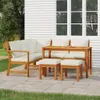 An outdoor dining set with cushions is placed on a patio next to a white house with windows. Podgląd zdjęcia produktu
