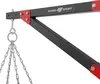 A close-up view of a black and red metal bracket with chains hanging from it, likely part of a boxing bag mount. Podgląd zdjęcia produktu