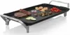 An electric griddle with food items on it. Voir les images du produit