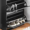 A close-up view of a black shoe cabinet with multiple shelves, displaying various shoes. Produktbild-Vorschau