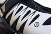 A close-up view of the side of a white and black inline skate, showing the mesh ventilation and a gold strap. Podgląd zdjęcia produktu