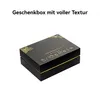 A black gift box with gold decorative elements and text on a white background. Produktbild-Vorschau