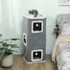 A cat is sitting on top of a multi-level cat tower in a bedroom setting next to a bed and a potted plant. Produktbild-Vorschau