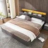 A bedroom scene featuring a modern upholstered bed with integrated lighting and storage. Produktbild-Vorschau