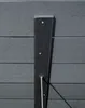 A close-up view of a dark gray composite material with vertical grooves, attached to a similar material with horizontal grooves. There are three visible screws and a metal rod extending downwards. Produktbild-Vorschau