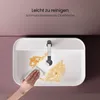A hand is wiping a dirty white sink with a cloth, with text overlay indicating easy cleaning. Voir les images du produit