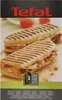 The image shows the packaging of a Tefal panini grill accessory set, featuring two panini sandwiches. Podgląd zdjęcia produktu