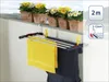A clothes drying rack is hanging on a balcony railing, with potted flowers in the background. Produktbild-Vorschau
