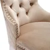 A close-up view of a beige upholstered chair, showing the tufted back and diamond-stitched armrest with decorative studs. Podgląd zdjęcia produktu