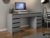 A gray desk with a computer and a plant on it, set in a room with a clock on the wall and a floor lamp and chair in the background. Produktbild-Vorschau