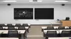 A classroom with two large blackboards on the wall and rows of desks and chairs in front of them. Náhled obrázku produktu