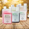 Bottles of liquid supplements for chickens are displayed on a wooden surface with a blurred autumn background. Produktbild-Vorschau