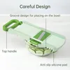 A mandoline slicer is shown on a countertop, with sliced cucumbers in a bowl underneath. Produktbild-Vorschau
