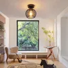A cozy living room scene with a ceiling light, armchair, guitar, and a decorative horse. Produktbild-Vorschau