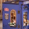 A close-up view of a miniature dollhouse tea room, showing architectural details and signage. Produktbild-Vorschau