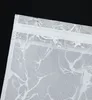 A close-up view of a white fabric curtain with a silver marble pattern and a white tunnel loop at the top. Produktbild-Vorschau