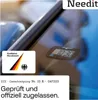 A close-up of a digital parking disc attached to a car windshield, with a German federal motor transport authority sticker next to it. Produktbild-Vorschau