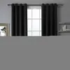 A close-up view of black curtains hanging in front of a window. Náhled obrázku produktu