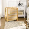 A bedroom scene with a laundry basket next to a nightstand. Náhľad obrázku produktu