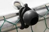A close-up of a black bungee cord with a ball end attached to a metal pole and a white tarp. Voir les images du produit