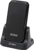 A black Olympia mobile phone is placed in its charging dock. Podgląd zdjęcia produktu