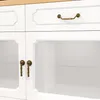 A close-up view of a white cabinet with brass hardware. Anteprima dell’immagine prodotto
