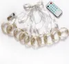 A string of fairy lights with a USB connector and a remote control, laid out on a white background. Produktbild-Vorschau
