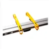 A close-up view of a yellow and gray metal stand. Produktbild-Vorschau