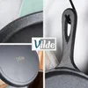 A collage of close-up shots of a cast iron frying pan, with a logo overlay. Produktbild-Vorschau