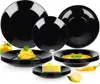 A collection of black dinnerware, including plates and bowls, with food items like spaghetti and cake arranged on some of them. Anteprima dell’immagine prodotto